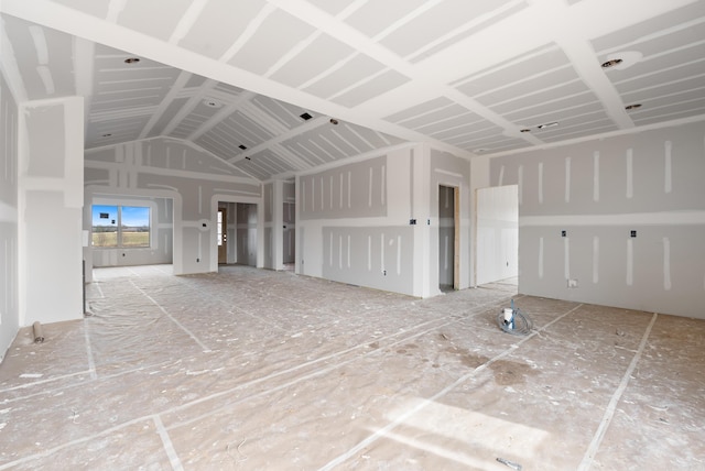 unfurnished living room featuring lofted ceiling