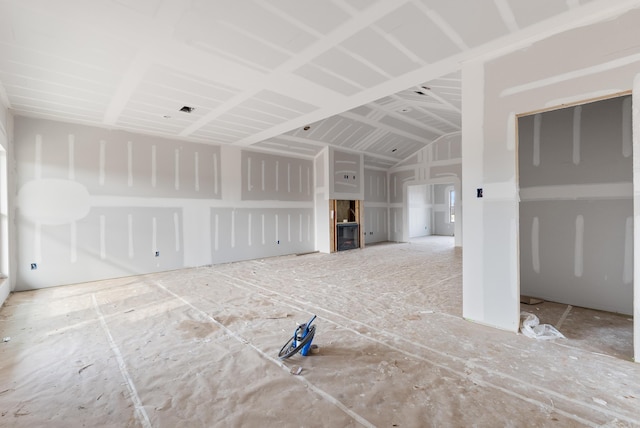 unfurnished living room featuring lofted ceiling