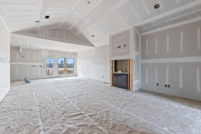 unfurnished living room featuring lofted ceiling and a fireplace