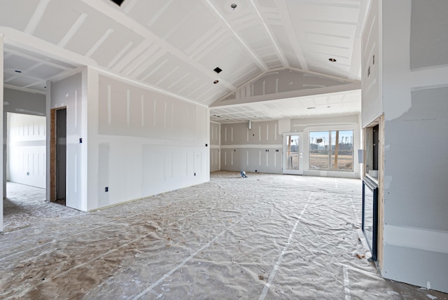 unfurnished living room featuring lofted ceiling