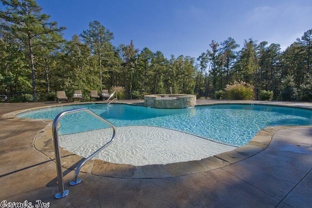 view of pool featuring a patio area and an in ground hot tub