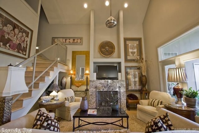 living room featuring high vaulted ceiling and a premium fireplace