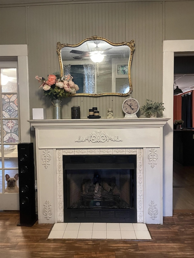 room details with a tile fireplace and hardwood / wood-style floors