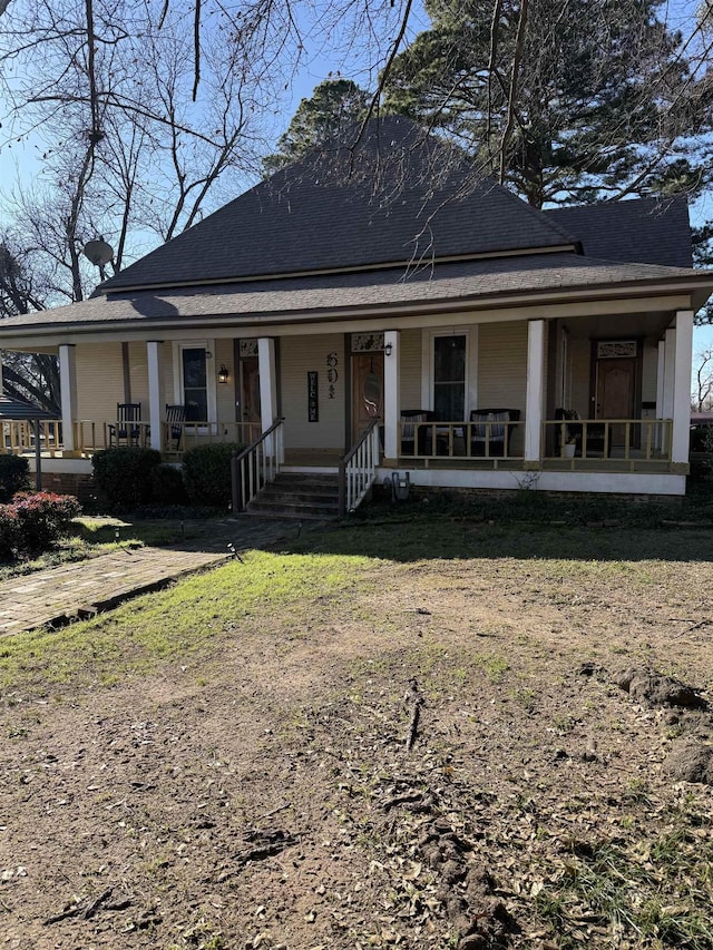 view of front of home with covered porch and a front yard