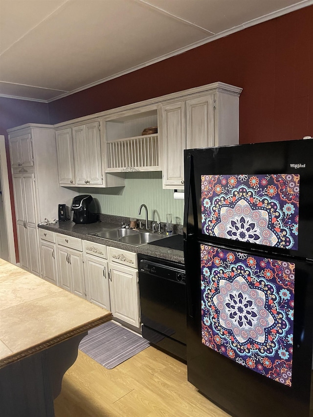 kitchen featuring black appliances, sink, crown molding, and light hardwood / wood-style flooring