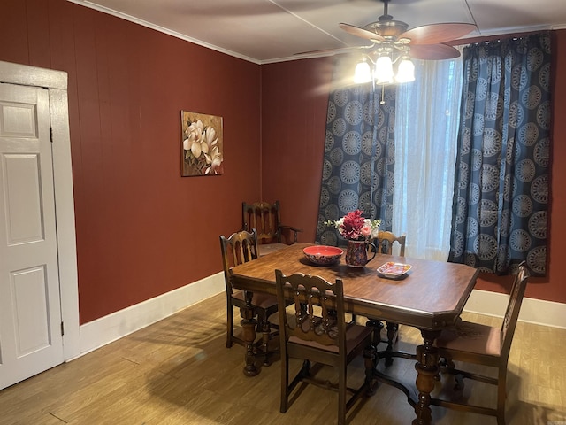 dining space featuring ceiling fan, crown molding, and wood-type flooring