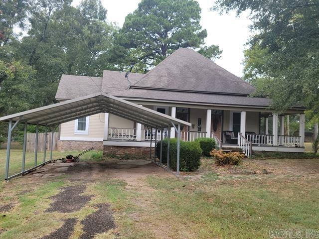 farmhouse inspired home featuring covered porch and a front yard