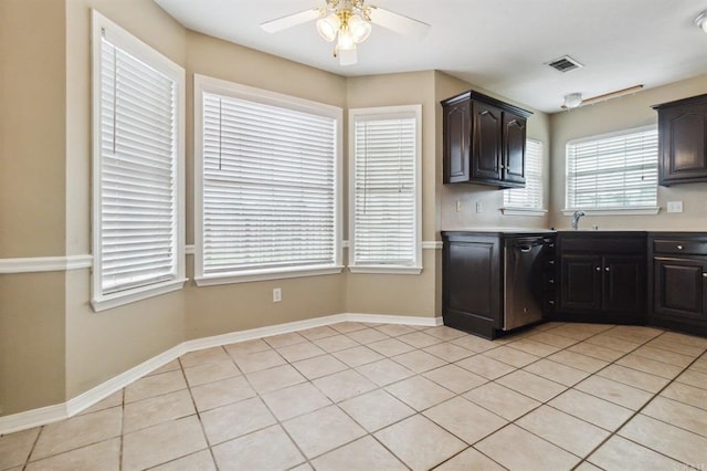 kitchen with dark brown cabinets, ceiling fan, light tile patterned floors, and stainless steel dishwasher