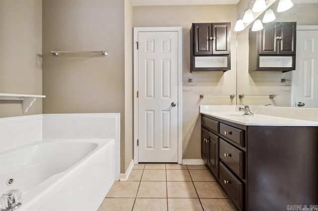 bathroom with a washtub, tile patterned floors, and vanity