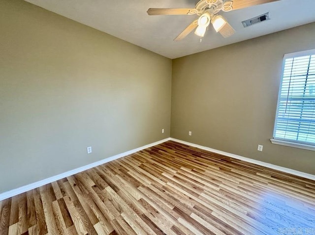 empty room featuring ceiling fan and hardwood / wood-style floors