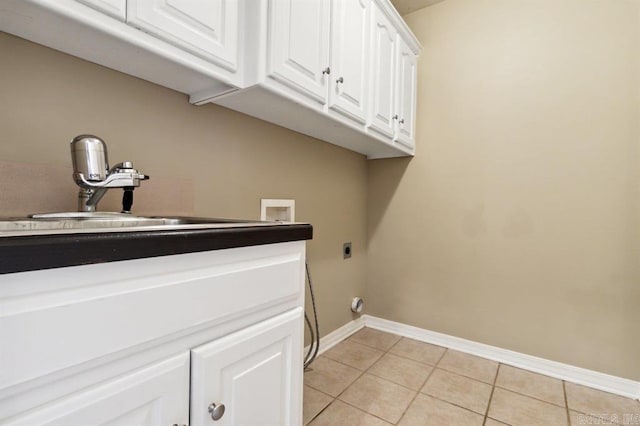 laundry room with light tile patterned floors, electric dryer hookup, hookup for a washing machine, cabinets, and sink