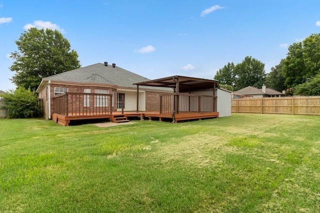 back of house with a wooden deck and a yard