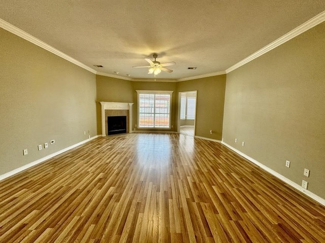 unfurnished living room featuring ceiling fan, wood-type flooring, crown molding, and a textured ceiling