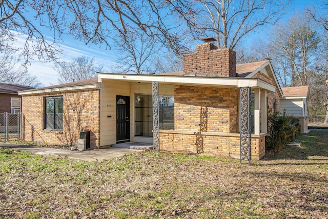 rear view of property featuring a patio area and a yard