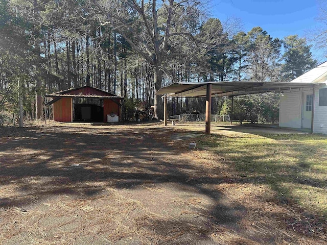 view of yard with a carport and an outdoor structure