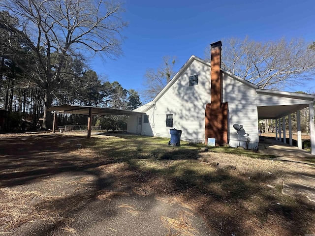 view of side of home with a carport