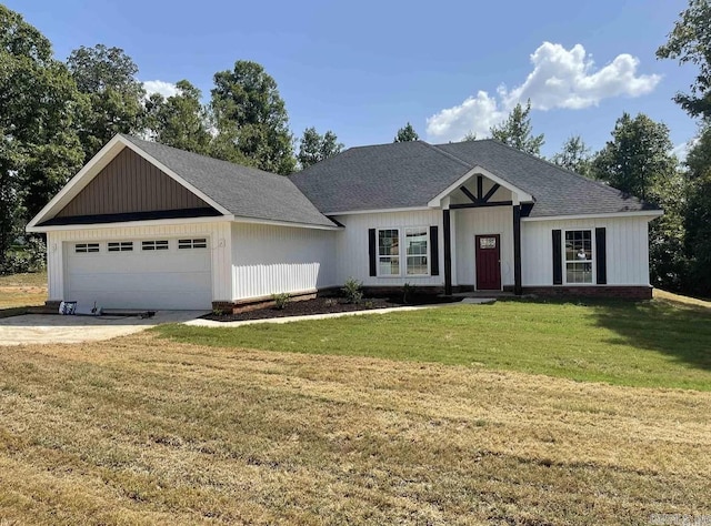 view of front of property featuring a garage and a front yard