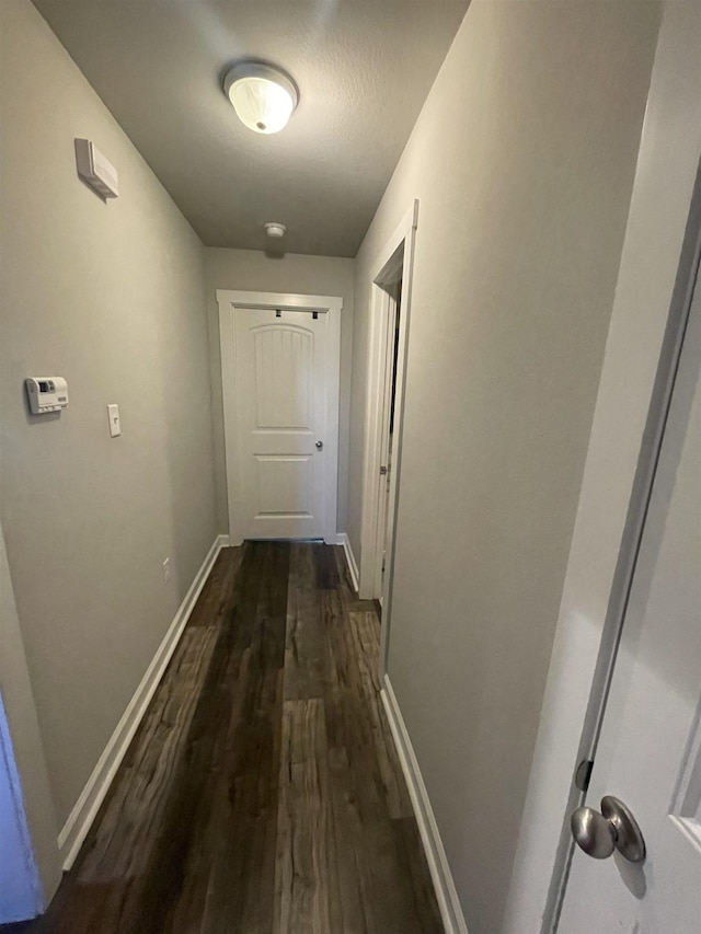 hallway with dark wood-type flooring