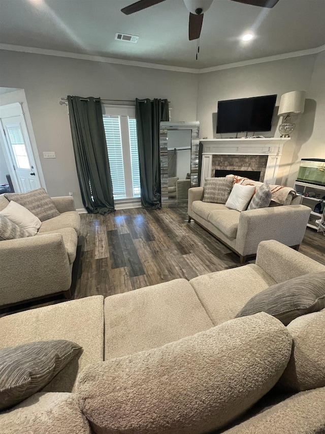 living room featuring dark hardwood / wood-style flooring, ornamental molding, and ceiling fan