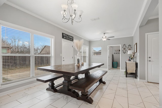 dining room featuring ceiling fan with notable chandelier, a wealth of natural light, and crown molding