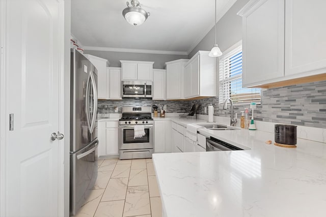 kitchen with decorative light fixtures, decorative backsplash, crown molding, appliances with stainless steel finishes, and white cabinets