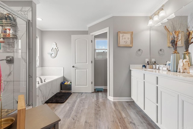 bathroom with separate shower and tub, crown molding, hardwood / wood-style floors, and vanity