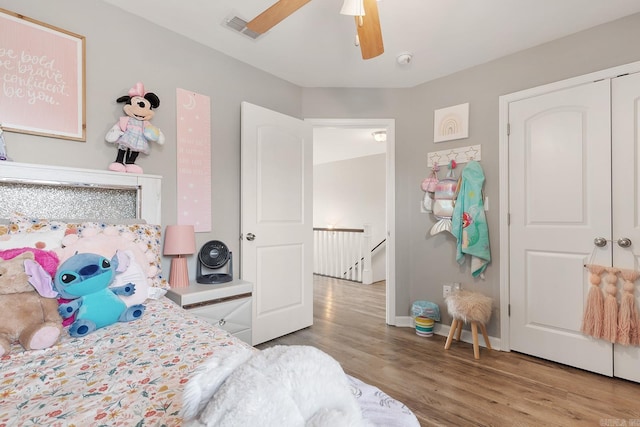 bedroom with ceiling fan, a closet, and hardwood / wood-style flooring