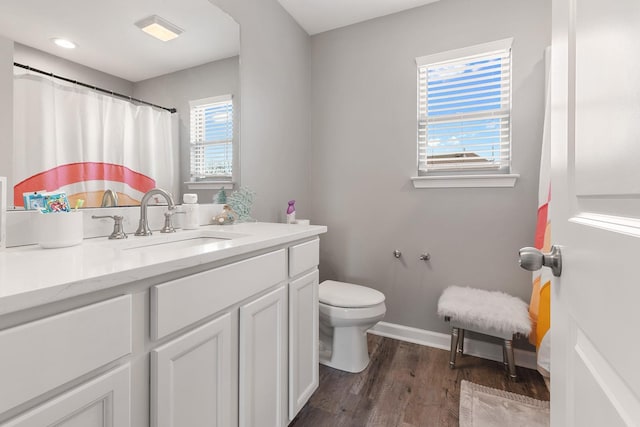 bathroom featuring curtained shower, wood-type flooring, toilet, and vanity