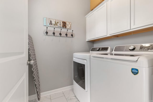 laundry area featuring independent washer and dryer and cabinets