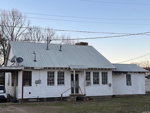 view of front of property featuring cooling unit and a lawn