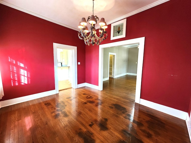 unfurnished dining area with ornamental molding, hardwood / wood-style flooring, and a notable chandelier