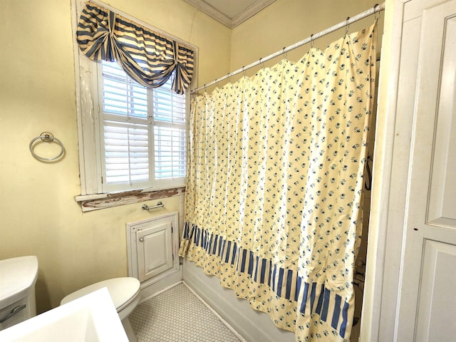 bathroom with toilet, ornamental molding, and shower / bath combo with shower curtain