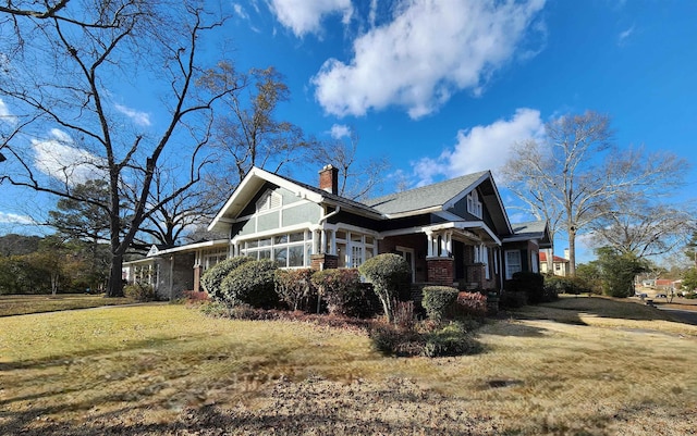 view of side of property featuring a yard