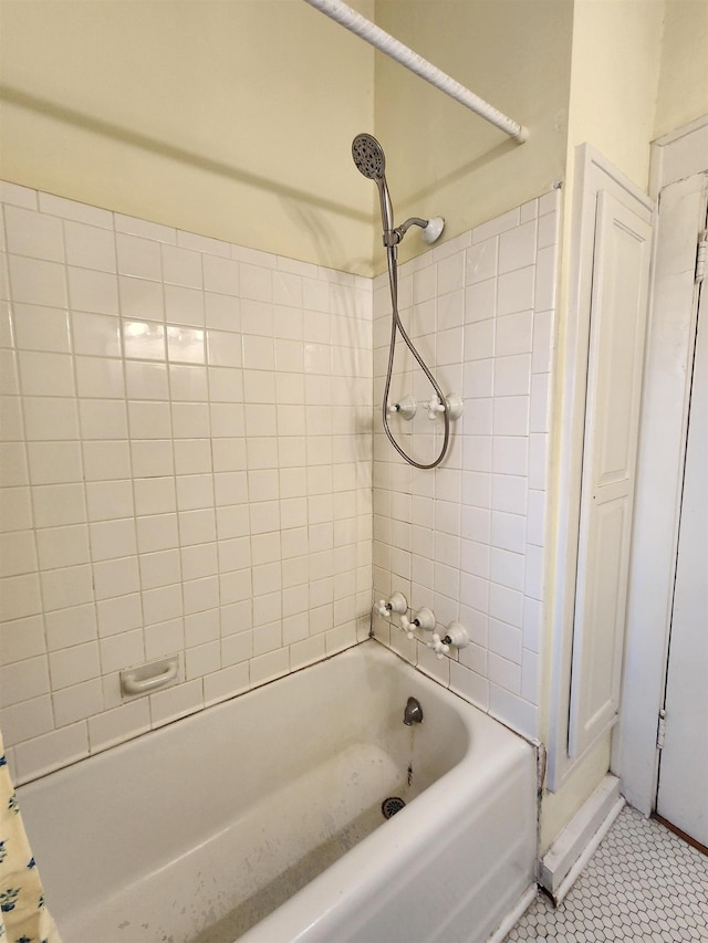 bathroom with tiled shower / bath and tile patterned flooring