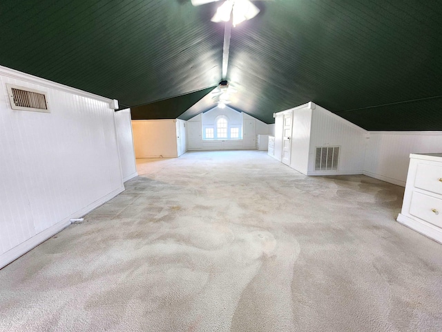 additional living space with light carpet and vaulted ceiling