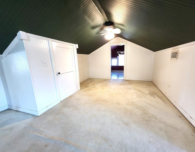 additional living space with lofted ceiling and light carpet