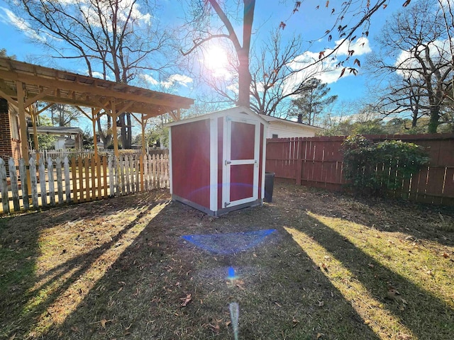 view of outdoor structure with a lawn and a pergola