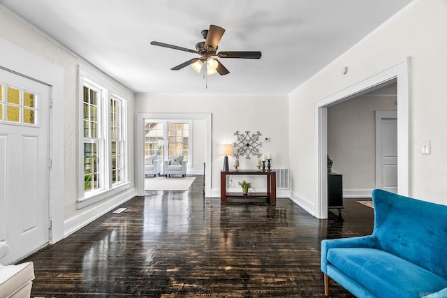 sitting room with ceiling fan and dark hardwood / wood-style flooring