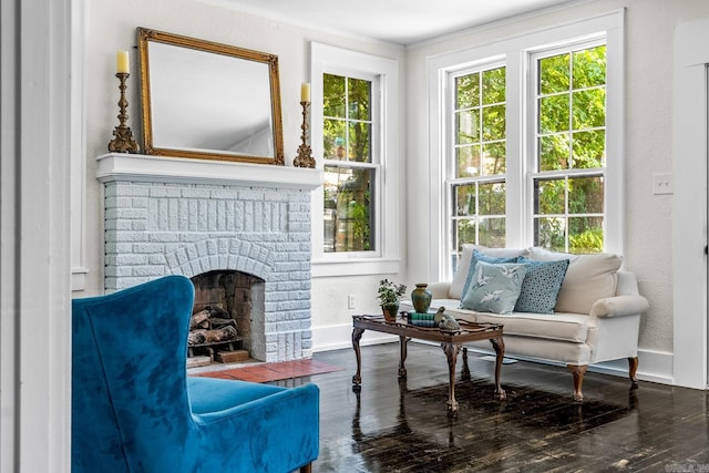 living area with a fireplace and dark hardwood / wood-style flooring