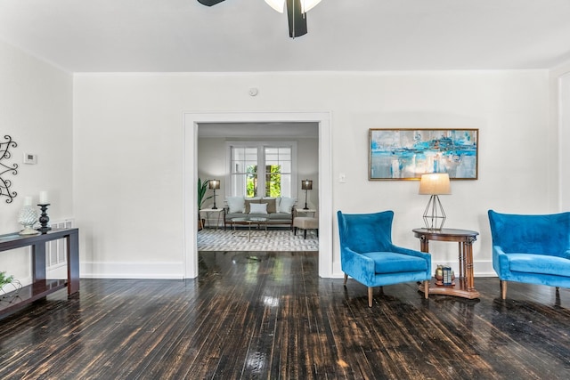 living area featuring hardwood / wood-style flooring and ceiling fan