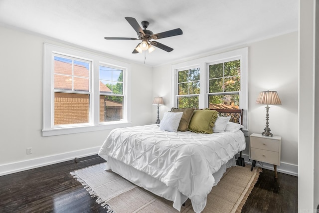 bedroom featuring ceiling fan, dark hardwood / wood-style floors, and ornamental molding