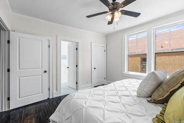 bedroom with ceiling fan, crown molding, connected bathroom, and dark hardwood / wood-style floors