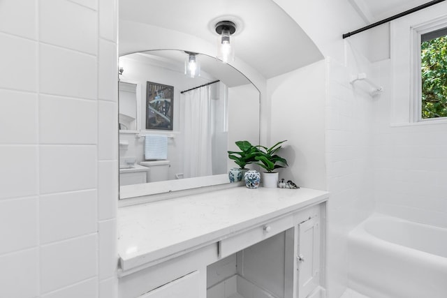 full bathroom featuring toilet, shower / bathtub combination with curtain, and vanity