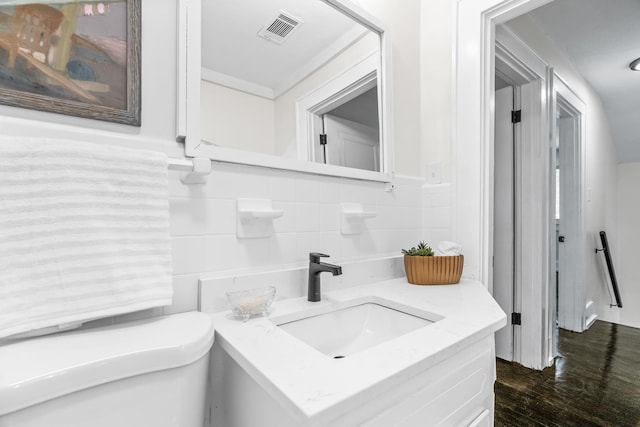 bathroom featuring hardwood / wood-style flooring, toilet, and vanity