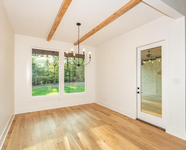 unfurnished dining area featuring an inviting chandelier, light hardwood / wood-style floors, and beamed ceiling