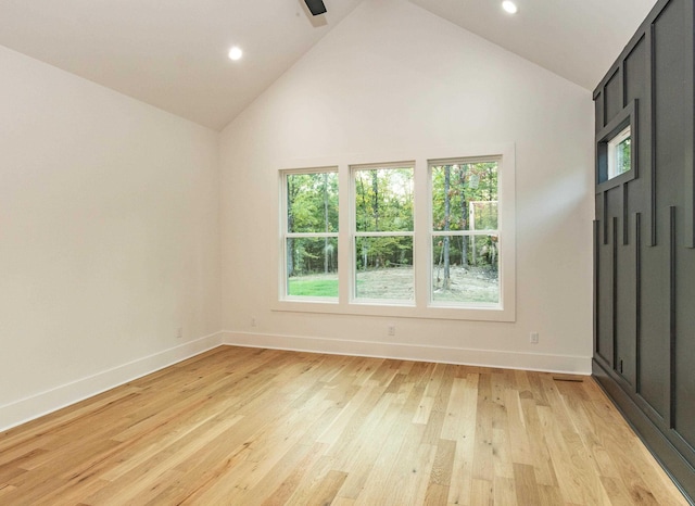 unfurnished room featuring light hardwood / wood-style floors and high vaulted ceiling