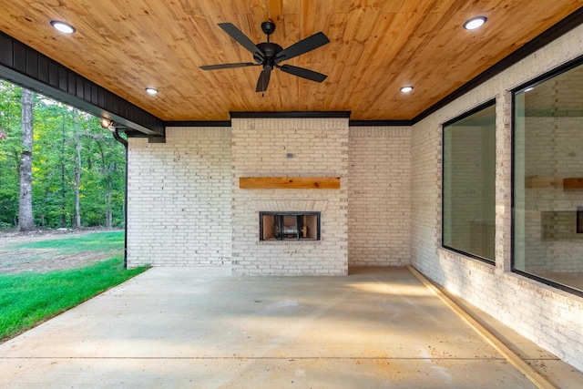 view of patio / terrace with ceiling fan and an outdoor brick fireplace