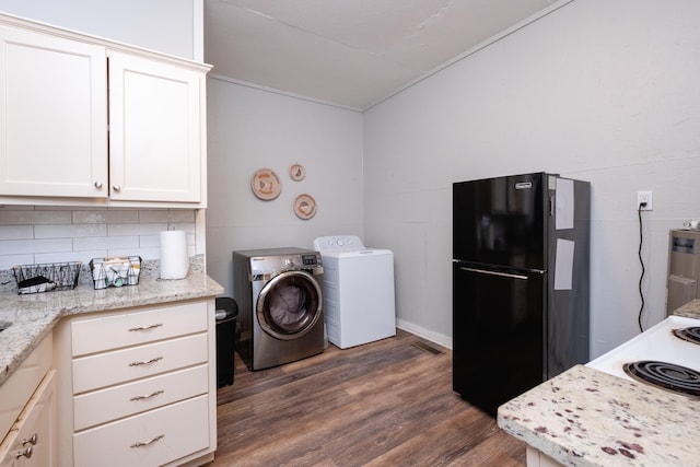 laundry area with dark hardwood / wood-style floors and washing machine and clothes dryer