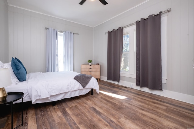 bedroom with ceiling fan, crown molding, and hardwood / wood-style floors