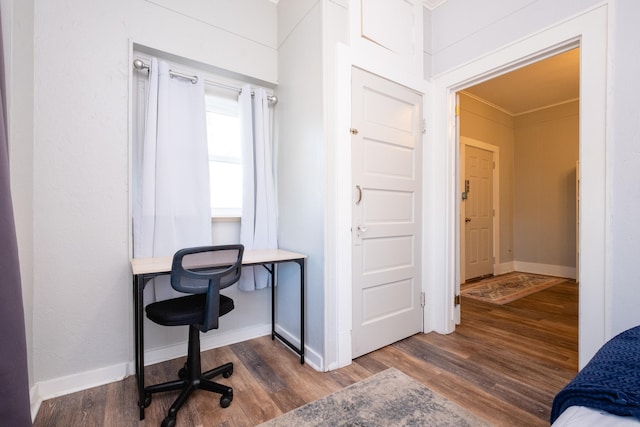 office space with dark wood-type flooring and ornamental molding